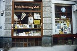 Window of a bookstore filled with small format pictures.