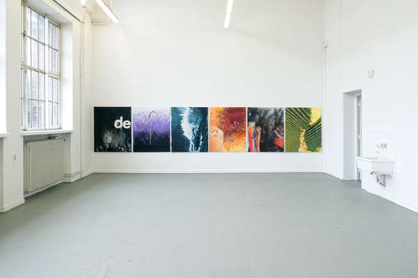 On the wall of a studio, six large-format paintings hang close together.