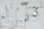 On a delicate steel framework with many branches, small objects are attached, like a little house.  
