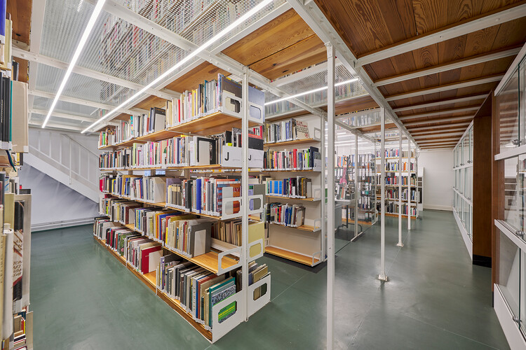 Bookshelves with books, glass ceiling with more bookshelves