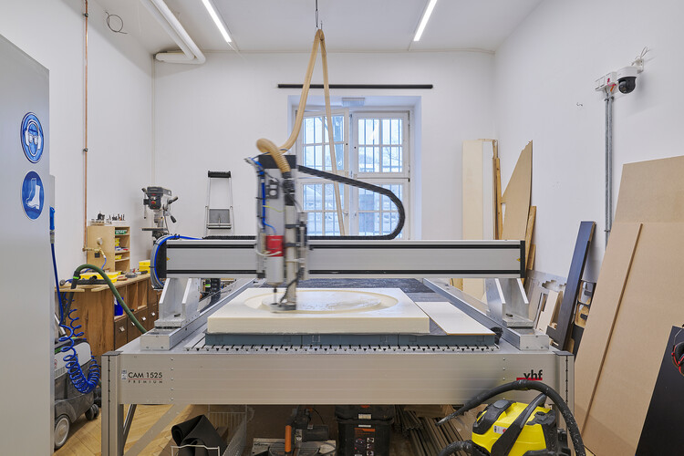 A milling arm moves through a plastic sheet.